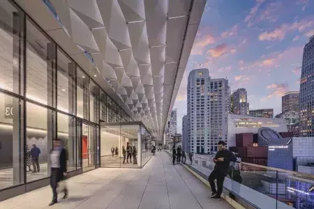 Meeting attendees stand and stroll on a balcony at 莫斯康尼中心 South in 威尼斯人官网平台app.